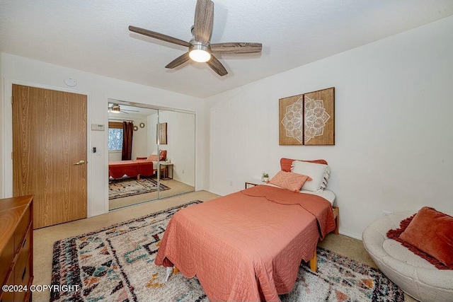 bedroom with light carpet, a closet, and ceiling fan