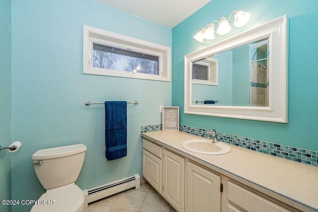 bathroom with tile patterned flooring, vanity, a baseboard radiator, and toilet