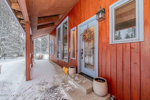 view of snow covered property entrance