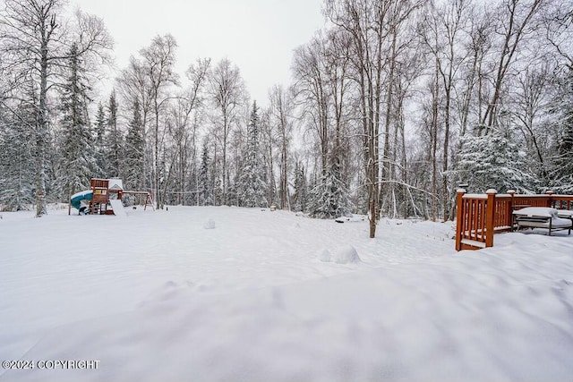 yard covered in snow with a playground