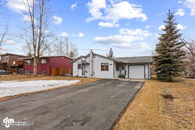 view of front of home featuring aphalt driveway and an attached garage