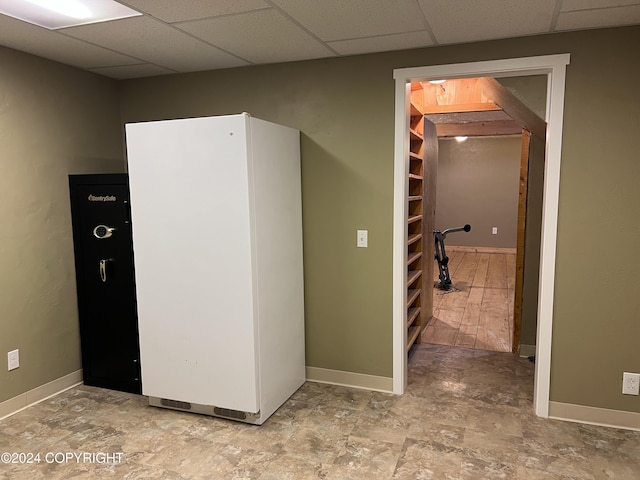 38400 Robinson Loop Rd, Sterling, AK 99672 - interior space with freestanding refrigerator, a paneled ceiling, baseboards, and stone finish floors