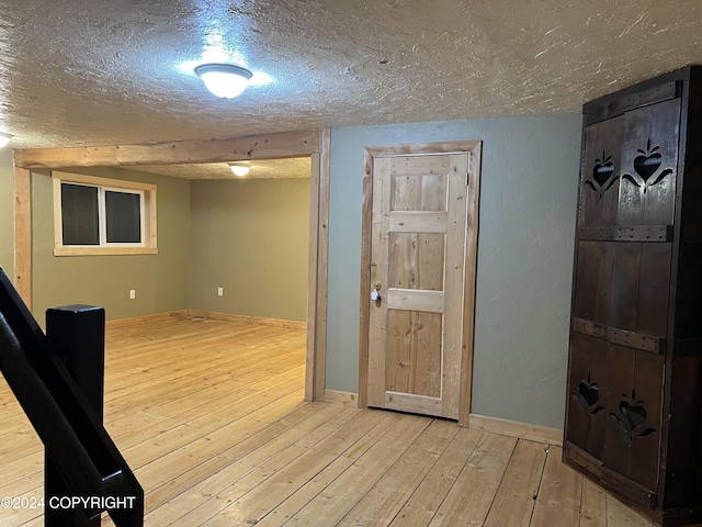 38400 Robinson Loop Rd, Sterling, AK 99672 - interior space with a textured ceiling, hardwood / wood-style flooring, and baseboards