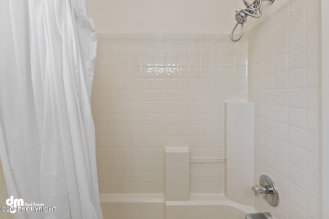 bathroom with shower / bath combo with shower curtain