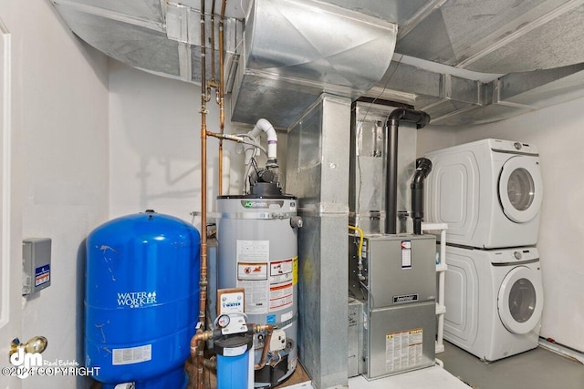 utility room featuring water heater and stacked washer and clothes dryer