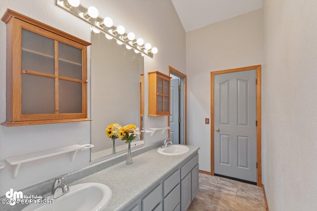 bathroom featuring vanity and vaulted ceiling