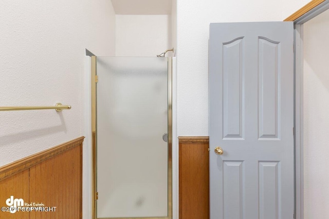 bathroom featuring a shower with door