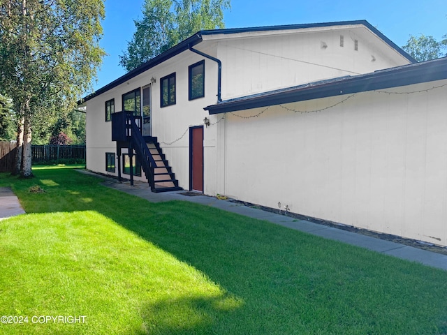 view of home's exterior with a lawn