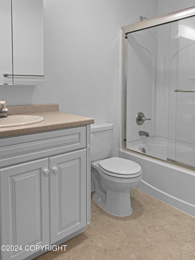 full bathroom featuring shower / bath combination with glass door, vanity, and toilet