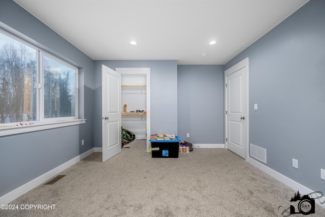 recreation room featuring light carpet