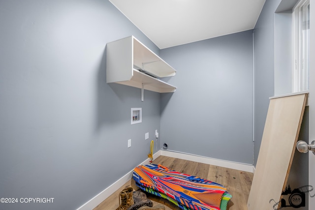 clothes washing area featuring light wood-type flooring and hookup for a washing machine