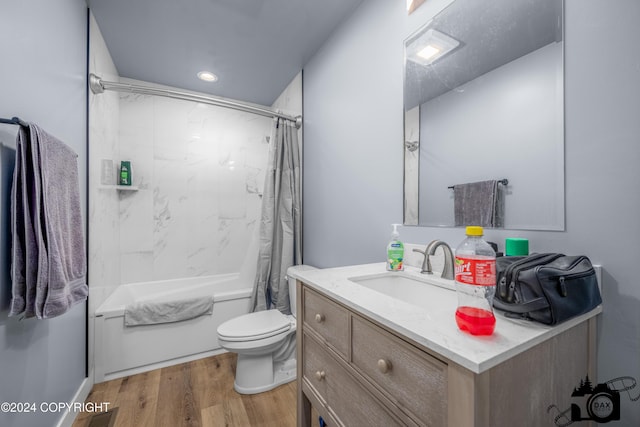 full bathroom featuring hardwood / wood-style floors, vanity, toilet, and shower / bath combo with shower curtain