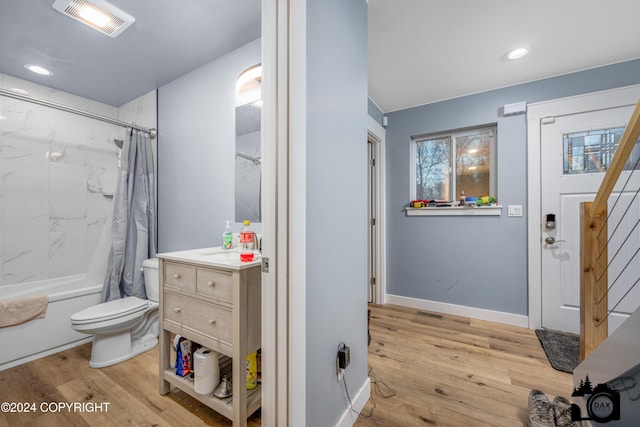 full bathroom with shower / bath combo with shower curtain, toilet, wood-type flooring, and vanity