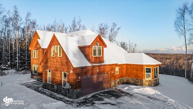 view of snow covered exterior with a garage