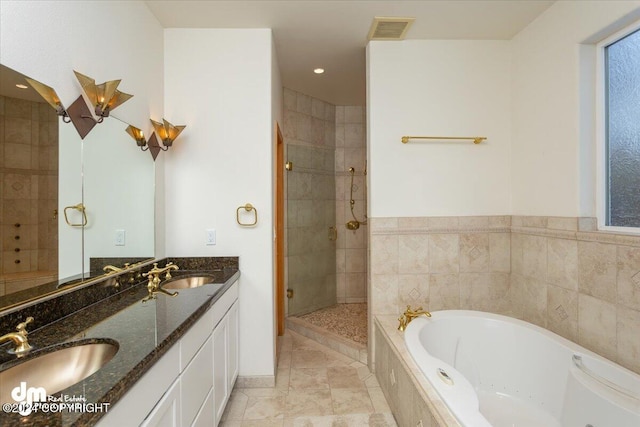 bathroom with vanity and independent shower and bath