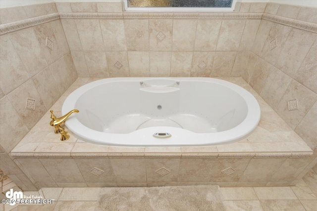 bathroom featuring tile patterned floors and tiled tub