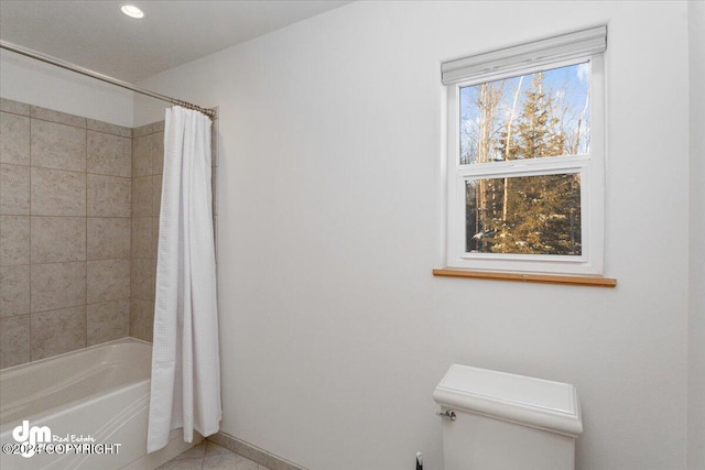 bathroom with tile patterned floors, shower / bathtub combination with curtain, and toilet