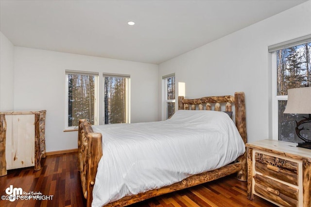 bedroom with dark hardwood / wood-style floors