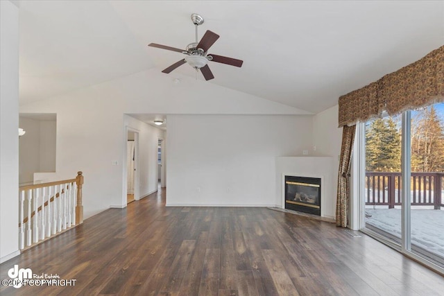 unfurnished living room with vaulted ceiling, ceiling fan, and dark wood-type flooring