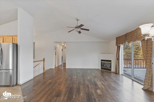 unfurnished living room with ceiling fan, dark wood-type flooring, and vaulted ceiling