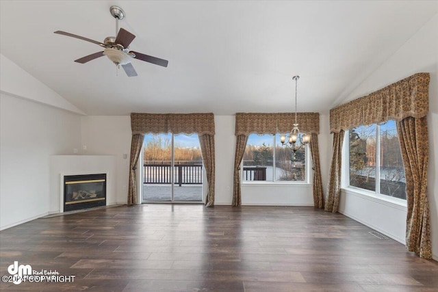 interior space with ceiling fan with notable chandelier, dark hardwood / wood-style flooring, and high vaulted ceiling