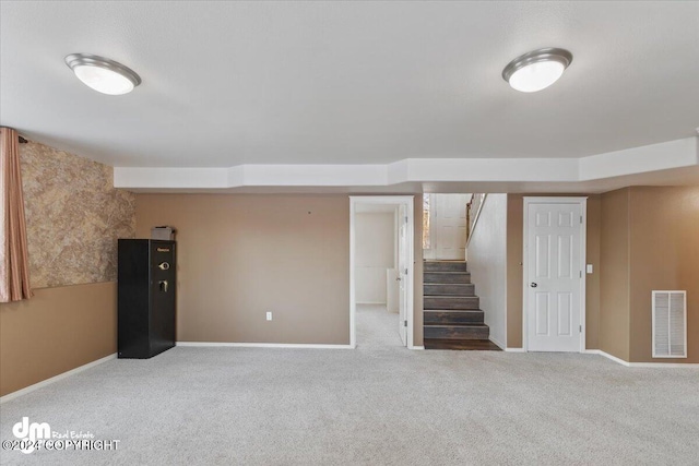 basement featuring light carpet