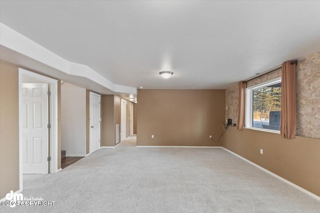 spare room featuring light colored carpet