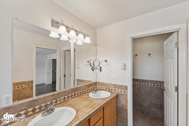 bathroom with vanity and tile walls