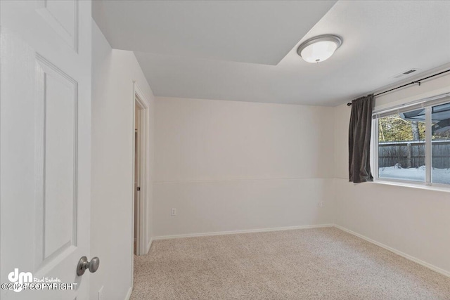 unfurnished room featuring light colored carpet