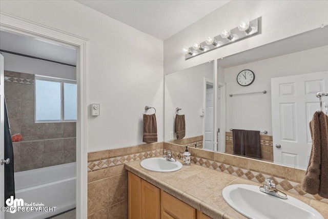 bathroom featuring vanity and tile walls