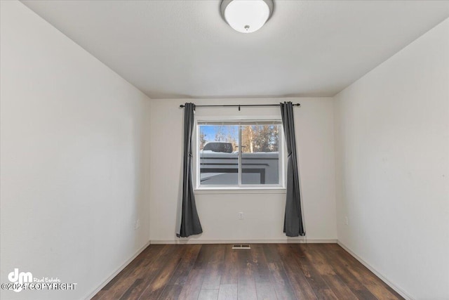 unfurnished room featuring dark hardwood / wood-style flooring