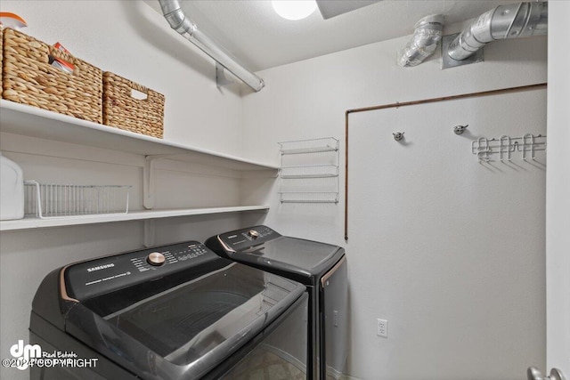 laundry room featuring washing machine and clothes dryer