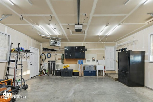 garage with black refrigerator and a garage door opener