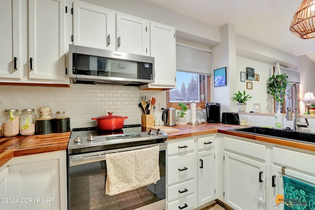 kitchen featuring wood counters, sink, white cabinetry, and stainless steel appliances