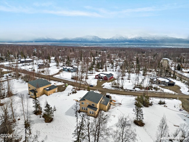 snowy aerial view with a mountain view