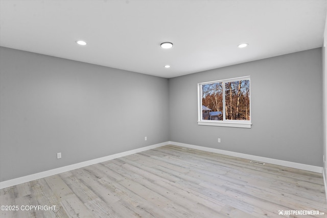 spare room with light hardwood / wood-style floors