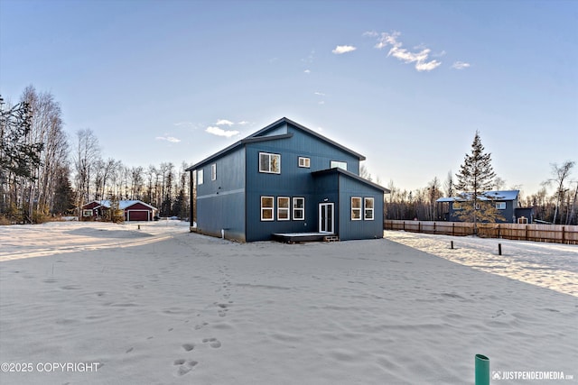 rear view of house featuring an outbuilding and a garage