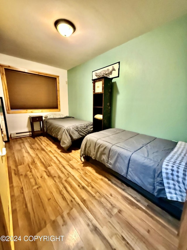 210A, 210B Brownell St, Seward, AK 99664 - bedroom with light hardwood / wood-style flooring and a baseboard heating unit