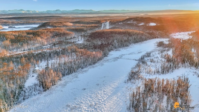 snowy aerial view with a mountain view