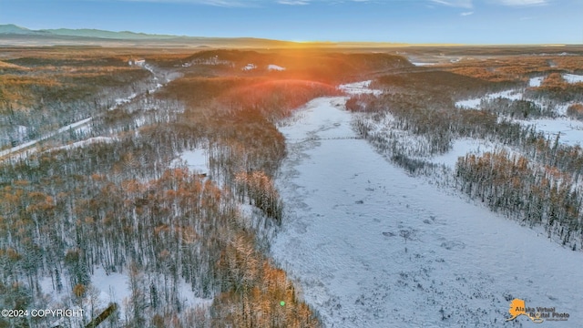 snowy aerial view with a mountain view