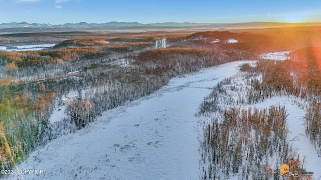 snowy aerial view featuring a mountain view