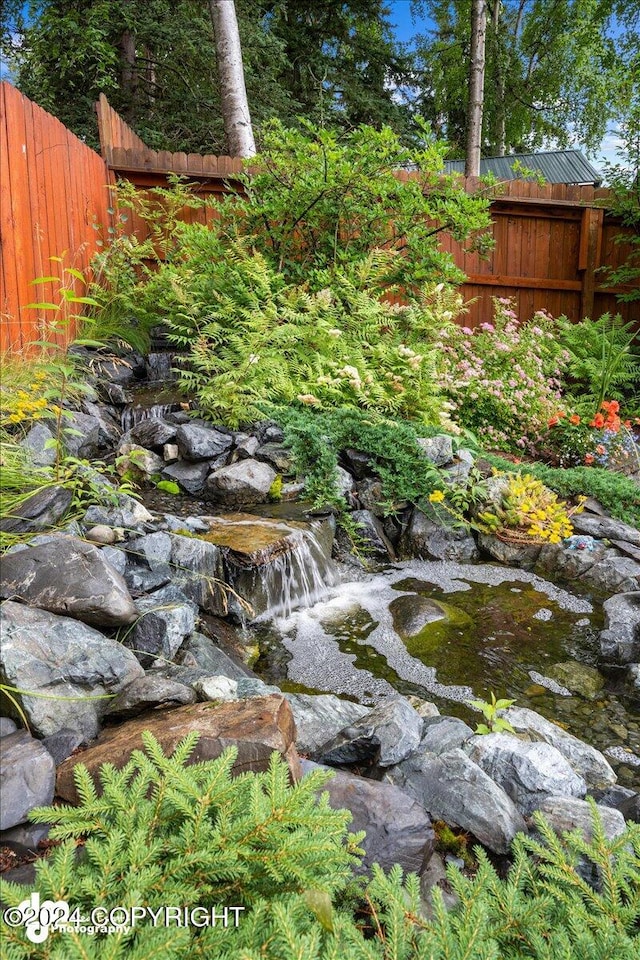 view of yard with a small pond