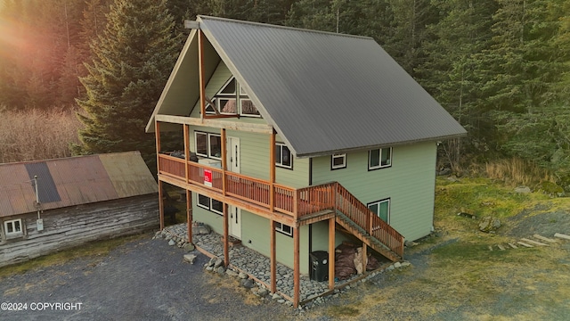 rear view of house featuring a wooden deck