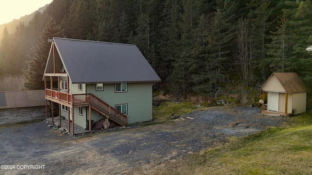 exterior space with a wooden deck and a shed