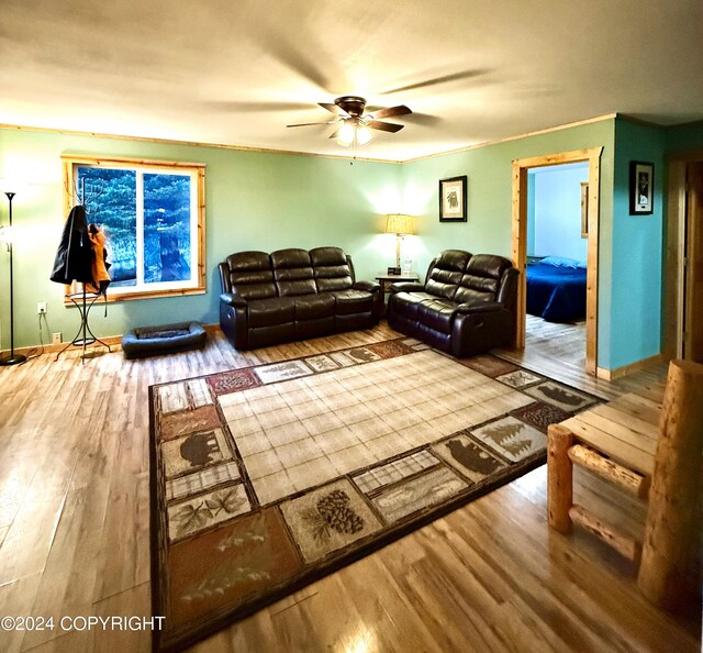 living room with ceiling fan, hardwood / wood-style floors, and crown molding