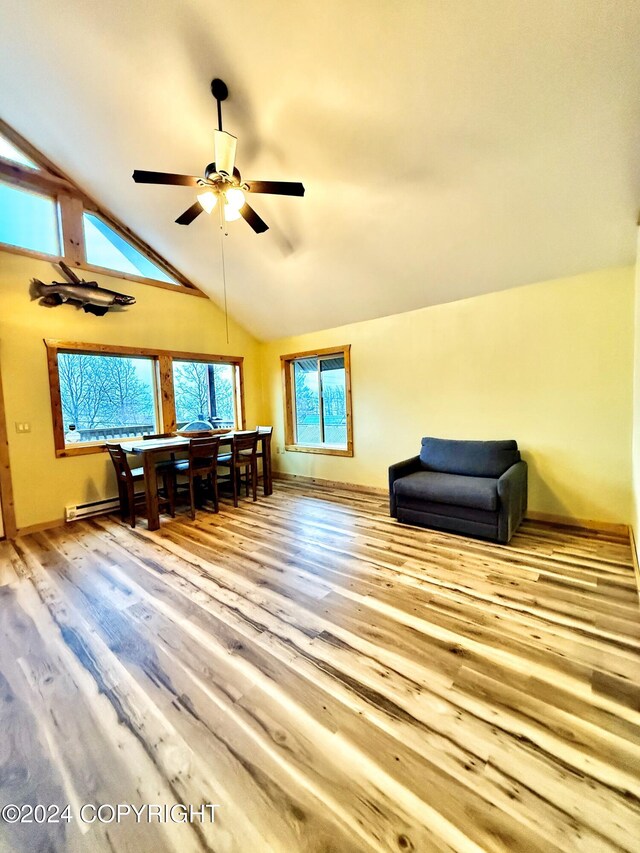 interior space with ceiling fan, lofted ceiling, and light hardwood / wood-style flooring