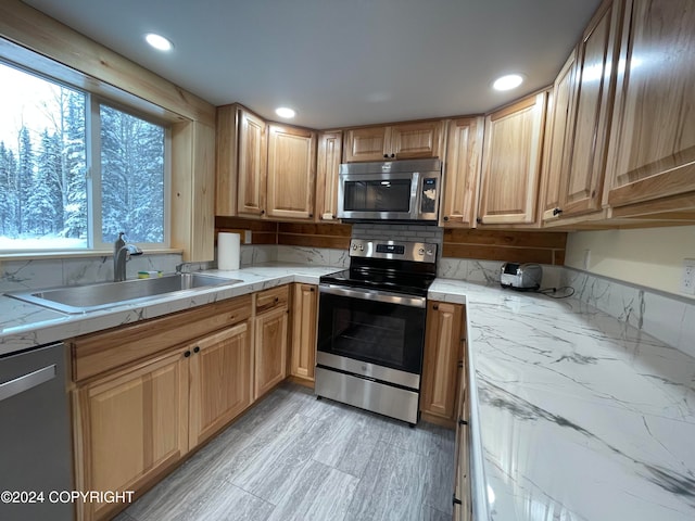 kitchen with decorative backsplash, stainless steel appliances, and sink