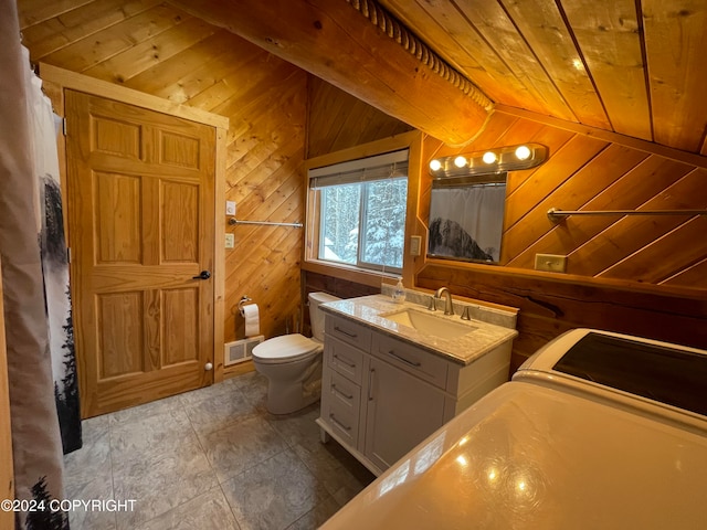 bathroom featuring wood ceiling, vanity, vaulted ceiling, toilet, and wood walls