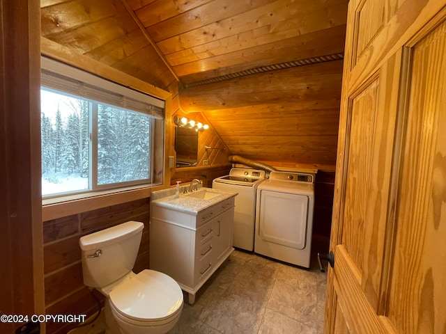 bathroom with vaulted ceiling, washer and clothes dryer, wooden walls, and wood ceiling