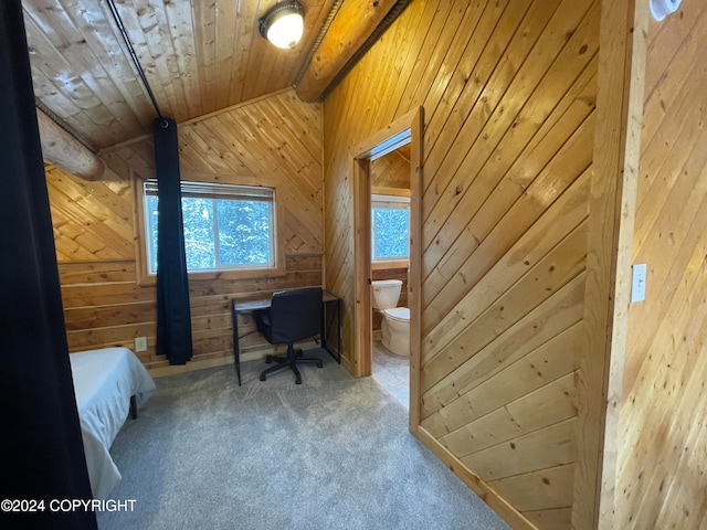 carpeted bedroom featuring lofted ceiling with beams, wooden ceiling, ensuite bath, and wooden walls